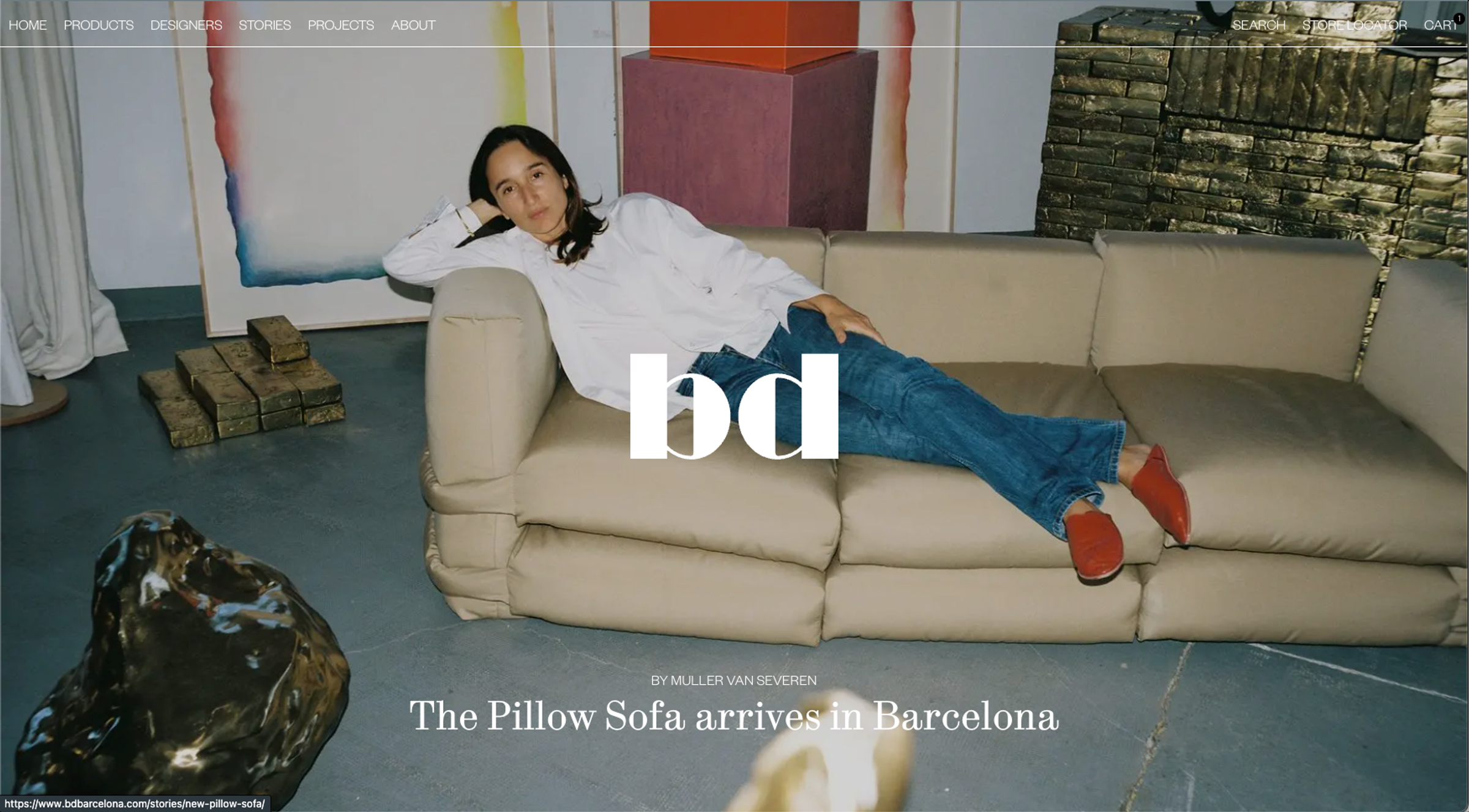 BD Barcelona home page: a woman lying on the Pillow Sofa in a showroom, with the bd logo