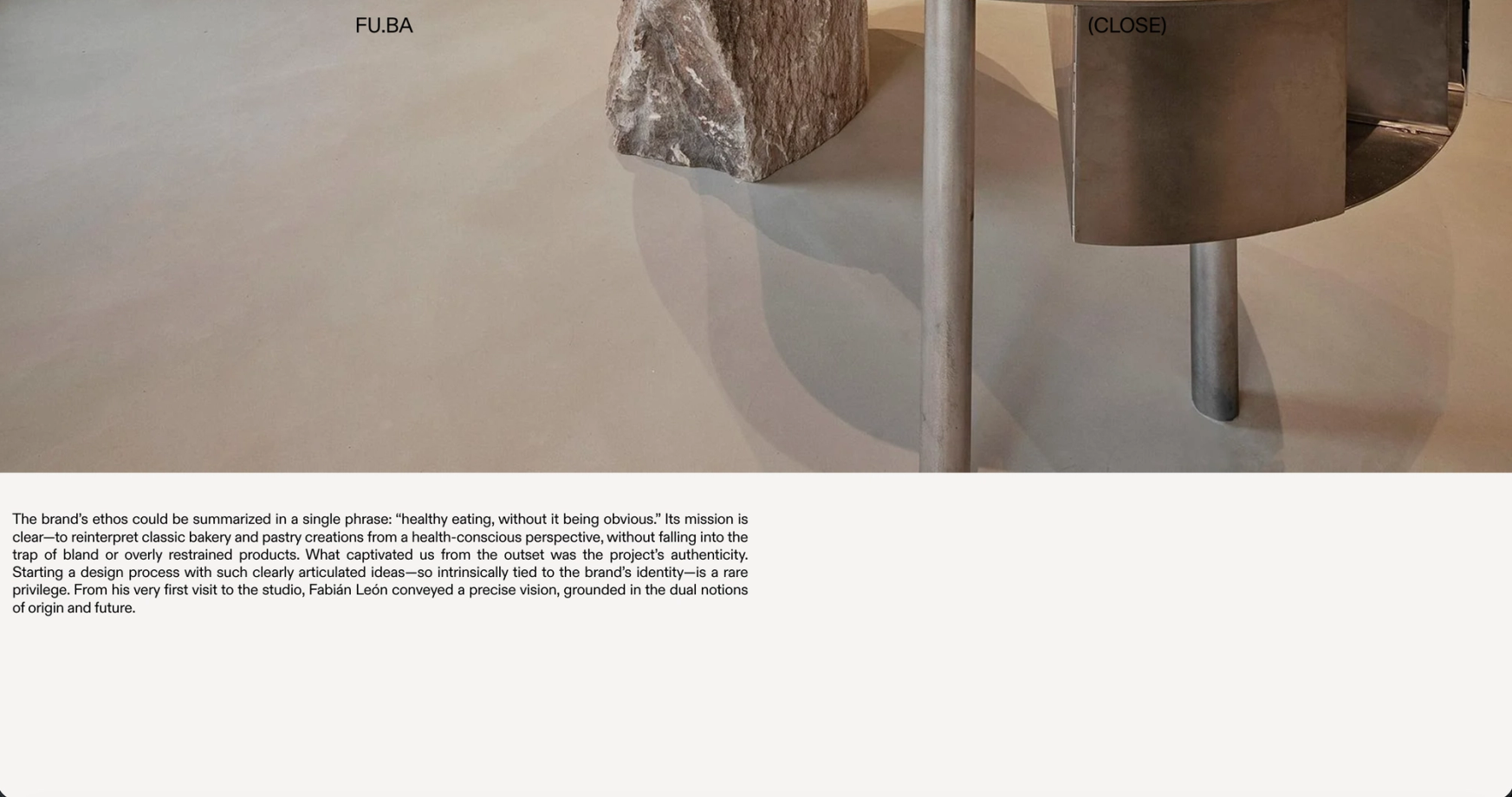 FU.BA project page: a close-up of a stone table on a stainless steel base, text below
