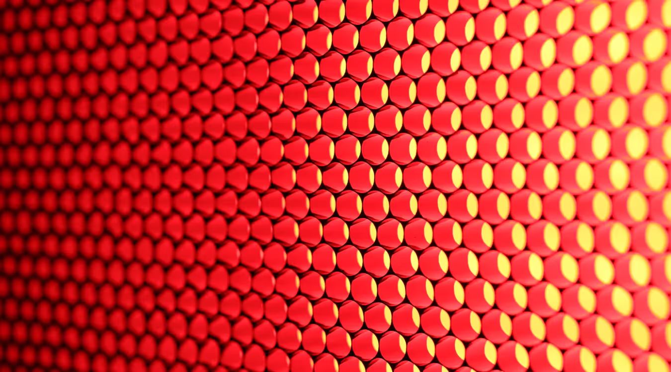 Grid of illuminated hexagonal light diodes transitioning from red to yellow across the surface