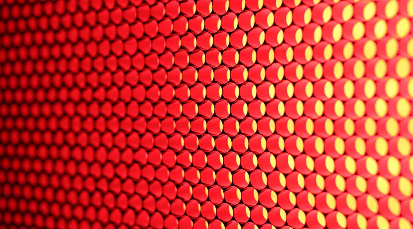 Grid of illuminated hexagonal light diodes transitioning from red to yellow across the surface