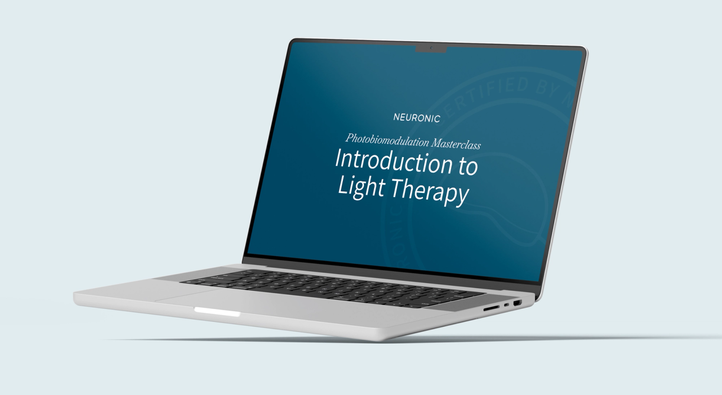 Laptop showing a Neuronic Photobiomodulation Masterclass for Clinicians video lesson.