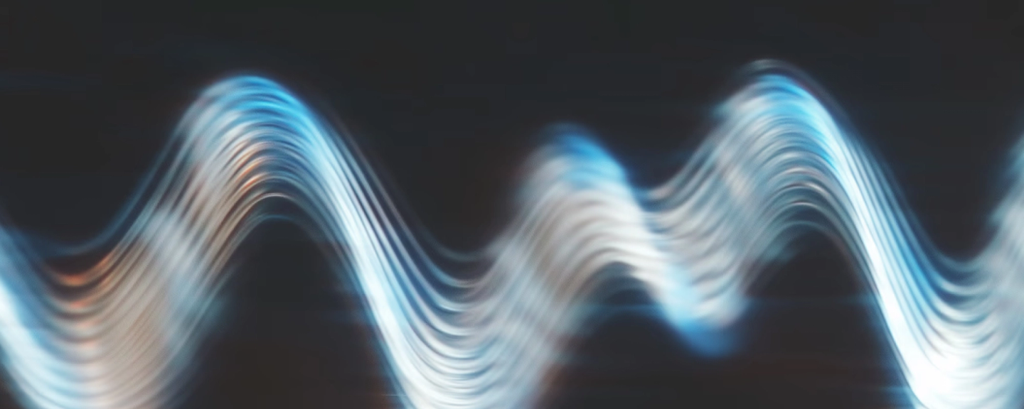 Abstract wavy light pattern with blue and white flowing lines against dark background