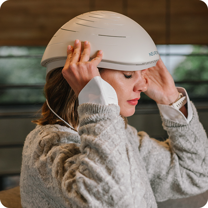 Man holding child wearing Neuronic Helmet, both looking toward window