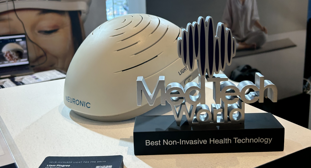 Neuronic Helmet on display desk next to Medtech World award for Best Non-Invasive Health Technology
