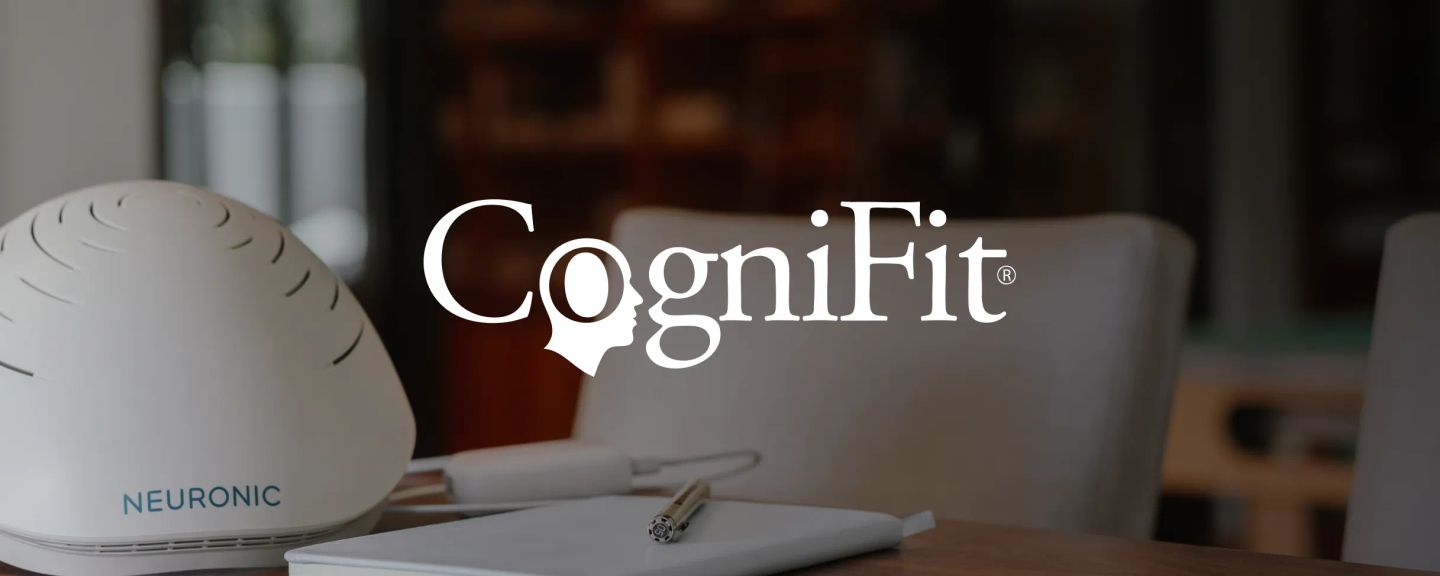 Neuronic Helmet on desk next to notebook and pen, with CogniFit logo and head icon overlay