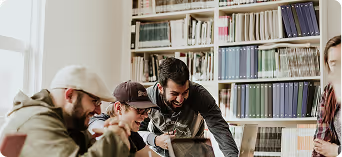 Three people examining a document together in front of a bookshelf
