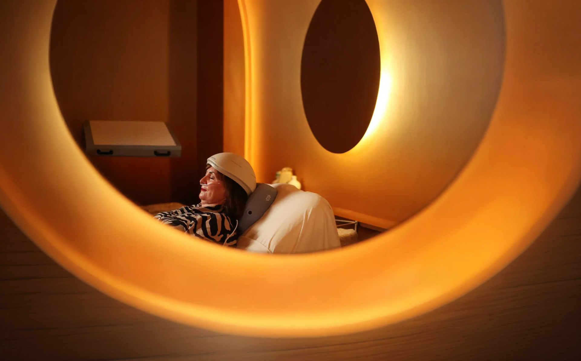 A guest relaxing in a hotel spa while wearing a Neuronic device