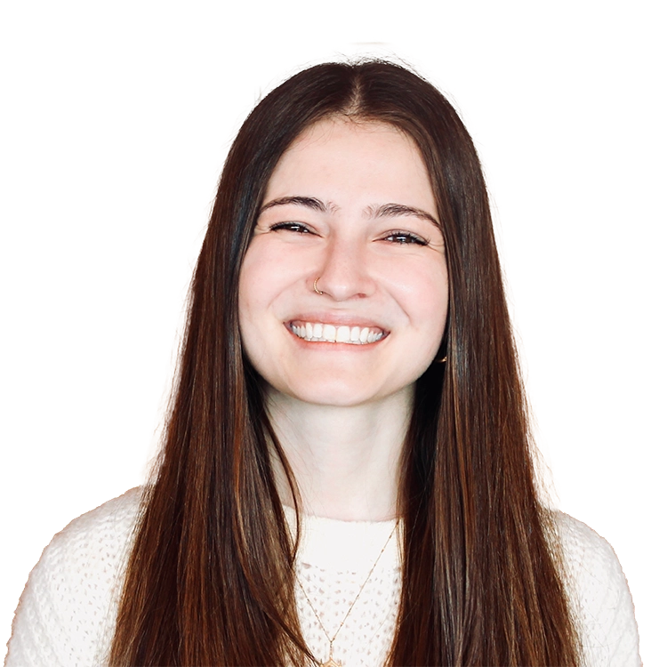 Woman with long dark hair smiling at camera, wearing a light-colored top