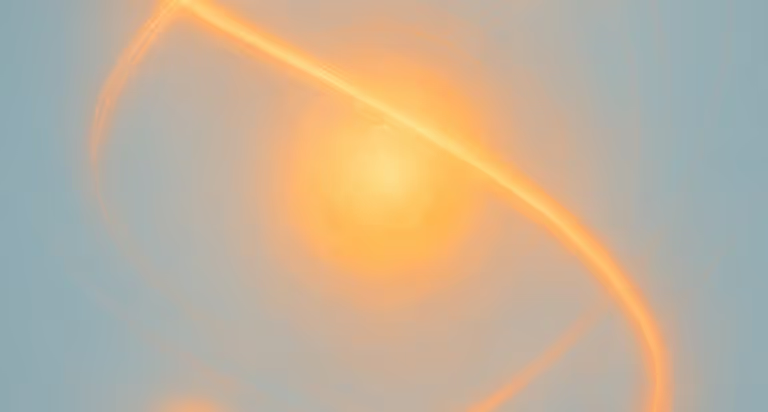 Warm orange light glow against soft blue and gray background