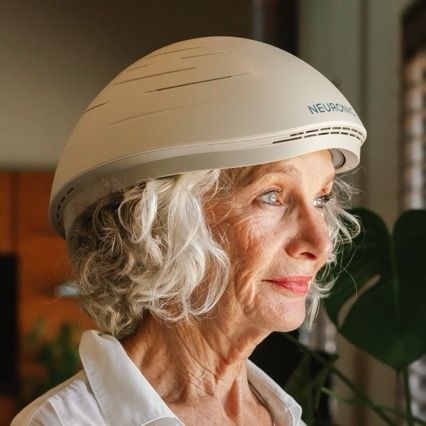 Older woman with white hair wearing a Neuronic helmet