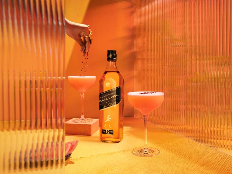 A bottle of Johnnie Walker Black with two cocktails in a bespoke black magic set  photographed by Jason Bailey Studio