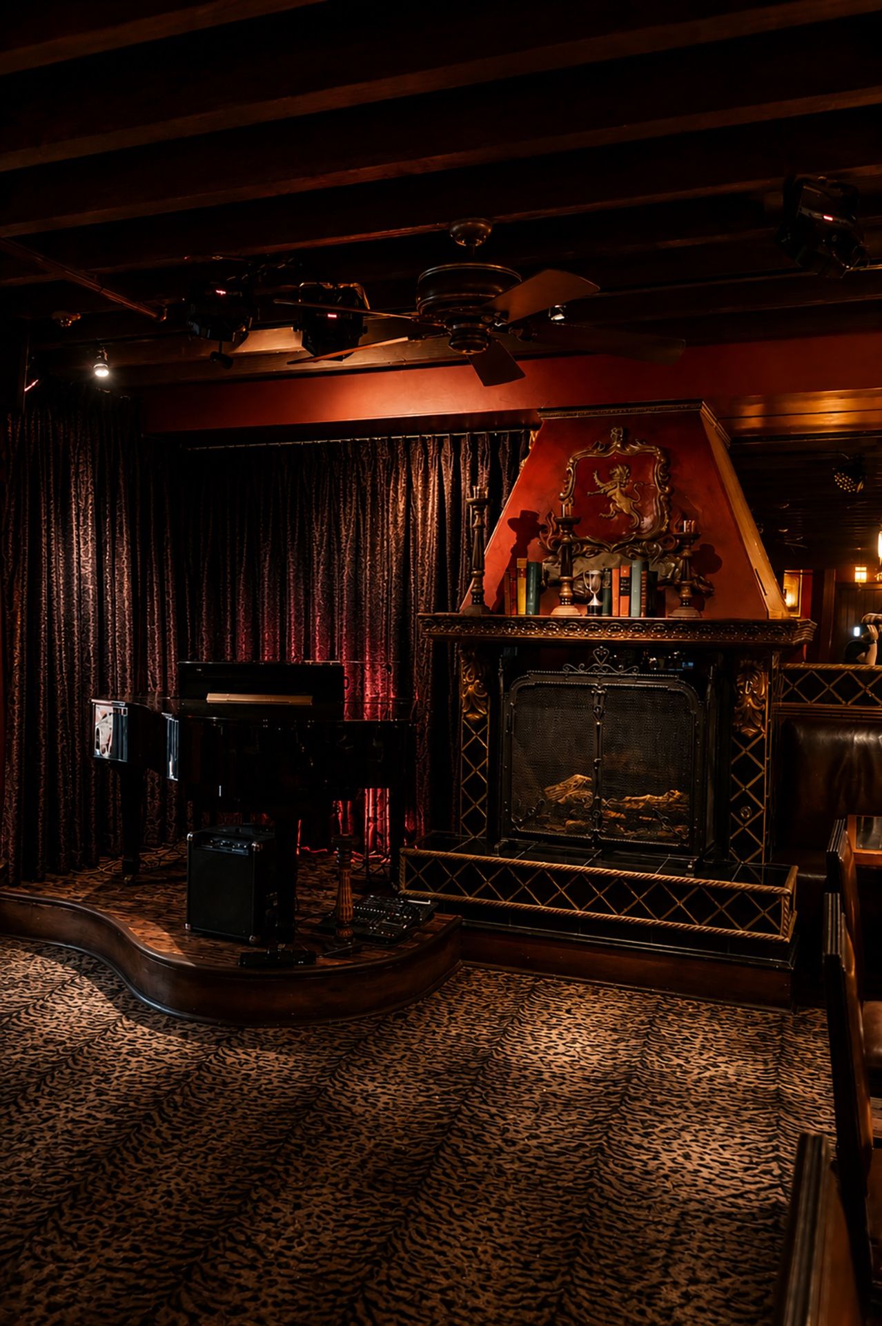 Piano beside the fireplace in the Durban Room under warm lighting