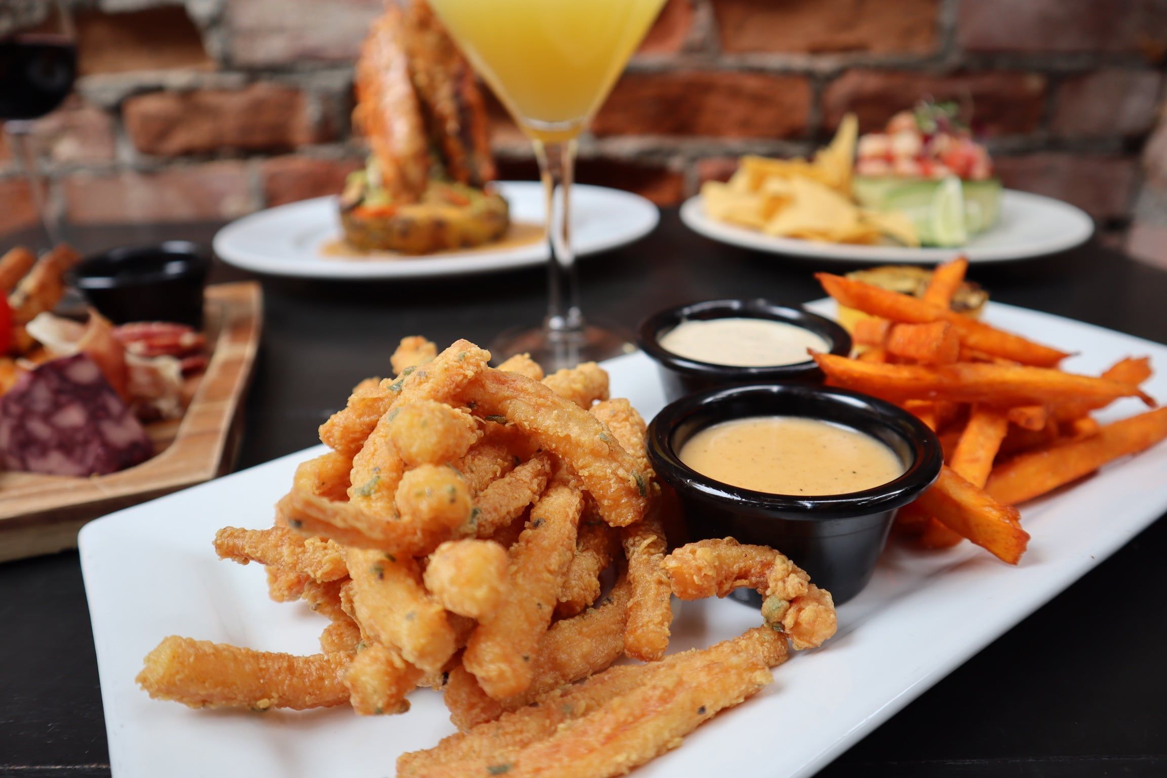 Fried calamari with dipping sauces and sweet potato fries