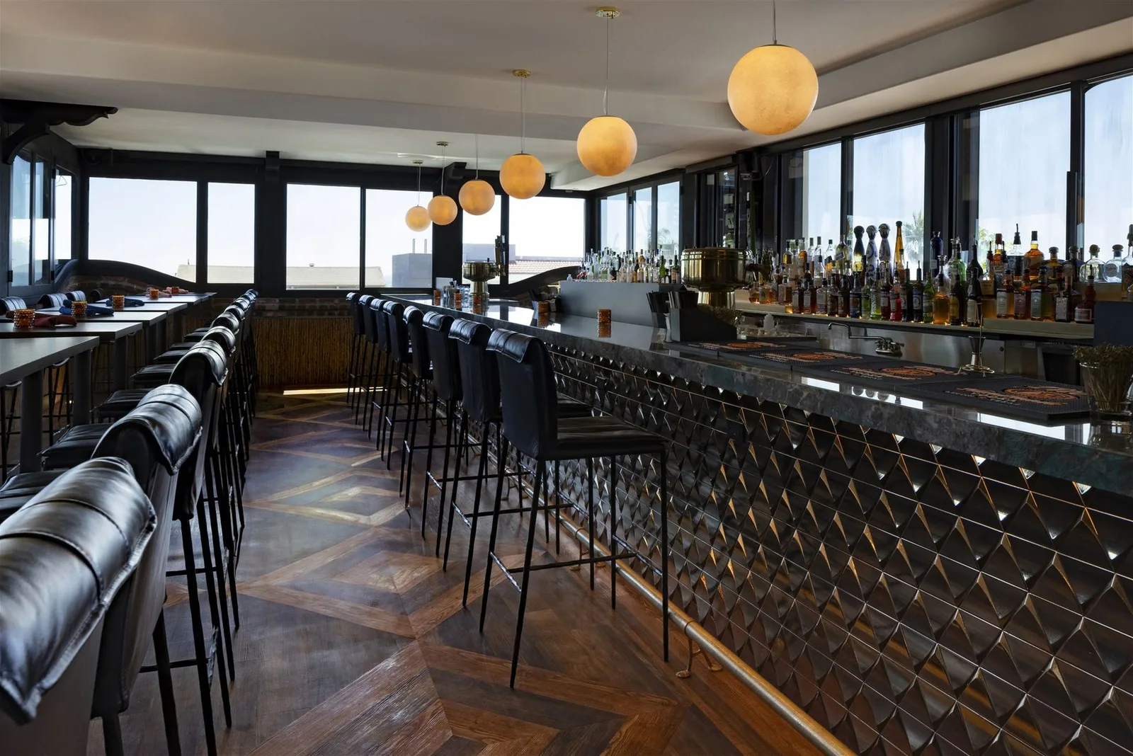 Long bar lined with leather stools at Ivan'z House
