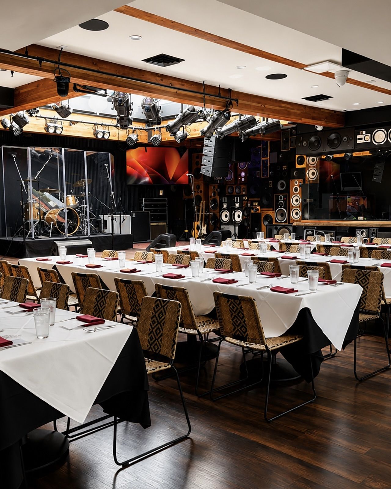 Ivan'z House set with white-linen banquet tables facing the stage