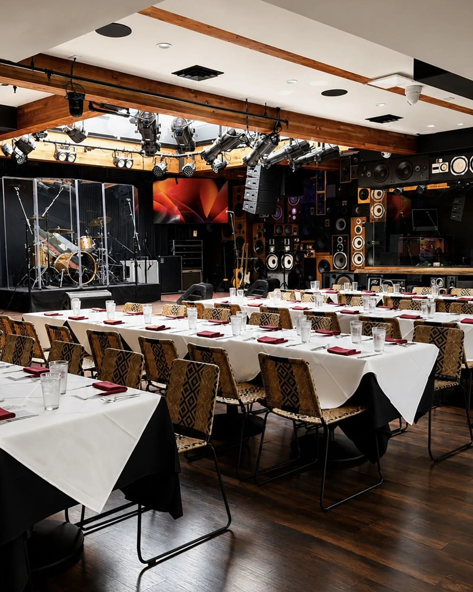 Ivan'z House set with white-linen banquet tables facing the stage