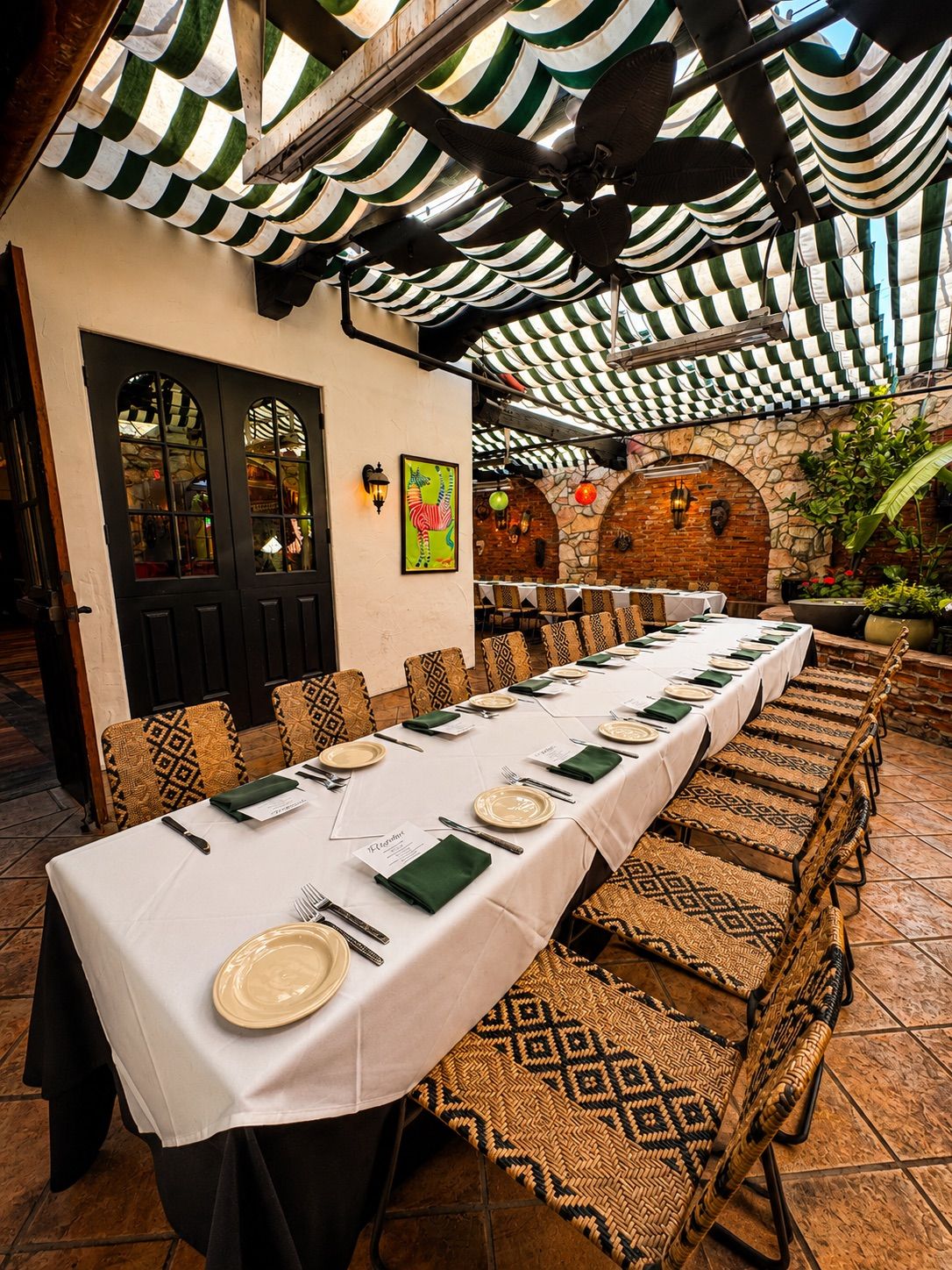 Banquet table set with white linens on the Garden Patio