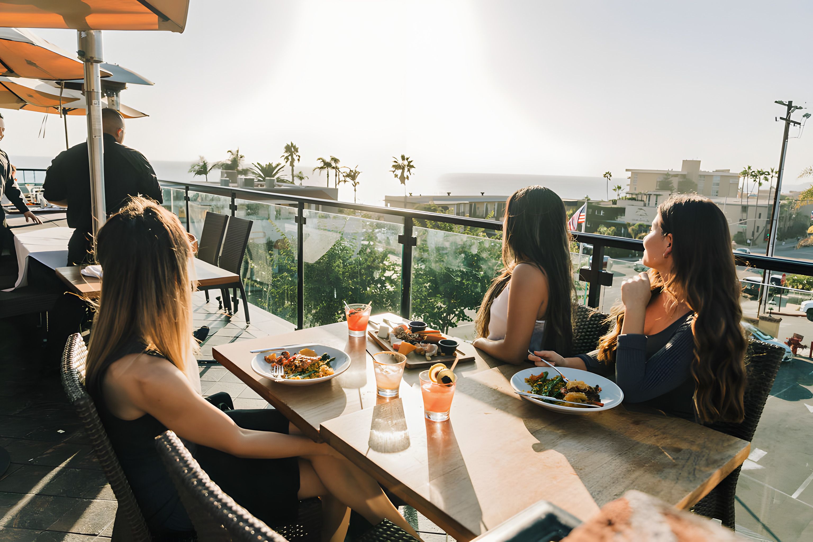 Three guests dining on the rooftop