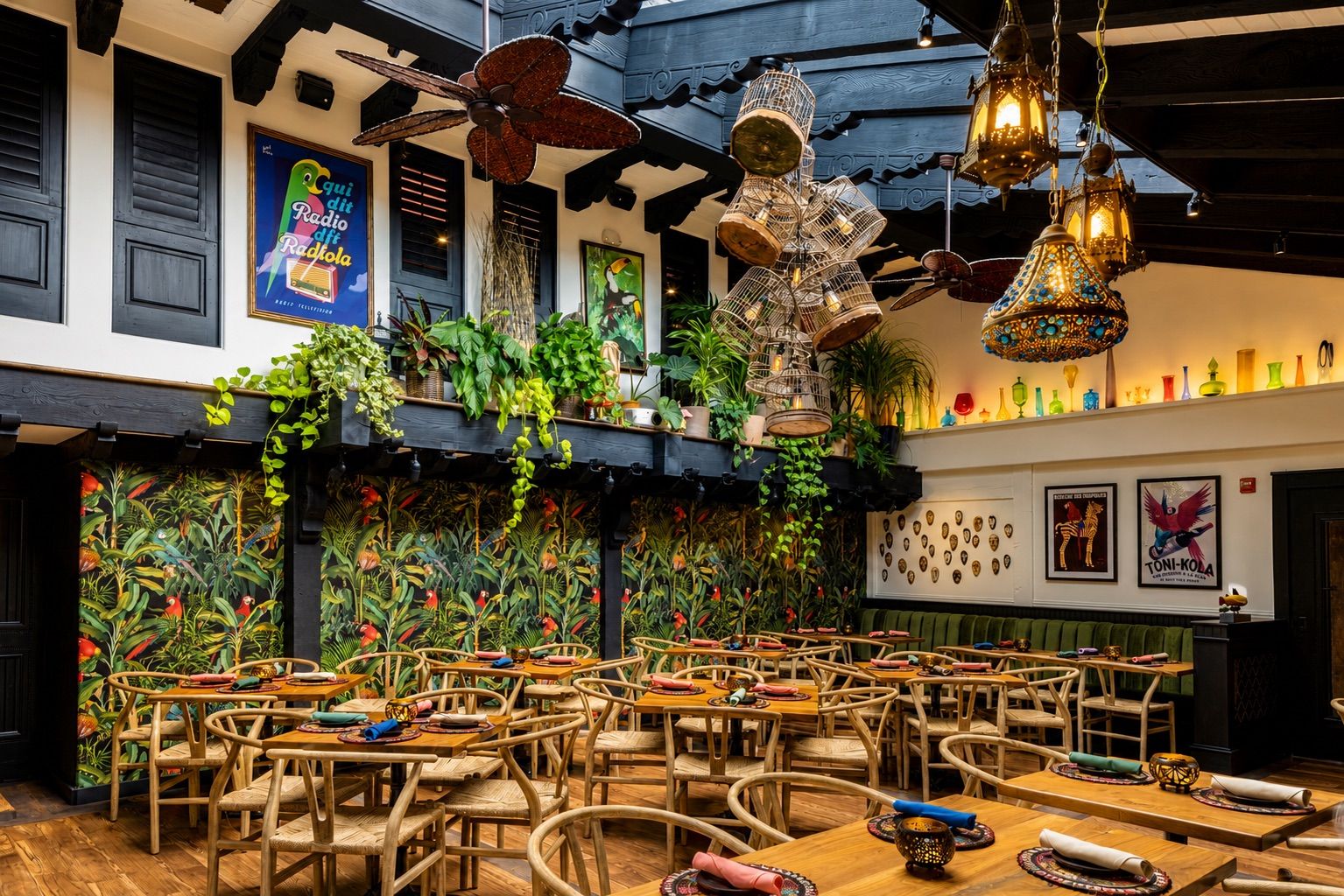 Parrot Room dining tables beneath hanging plants and lanterns