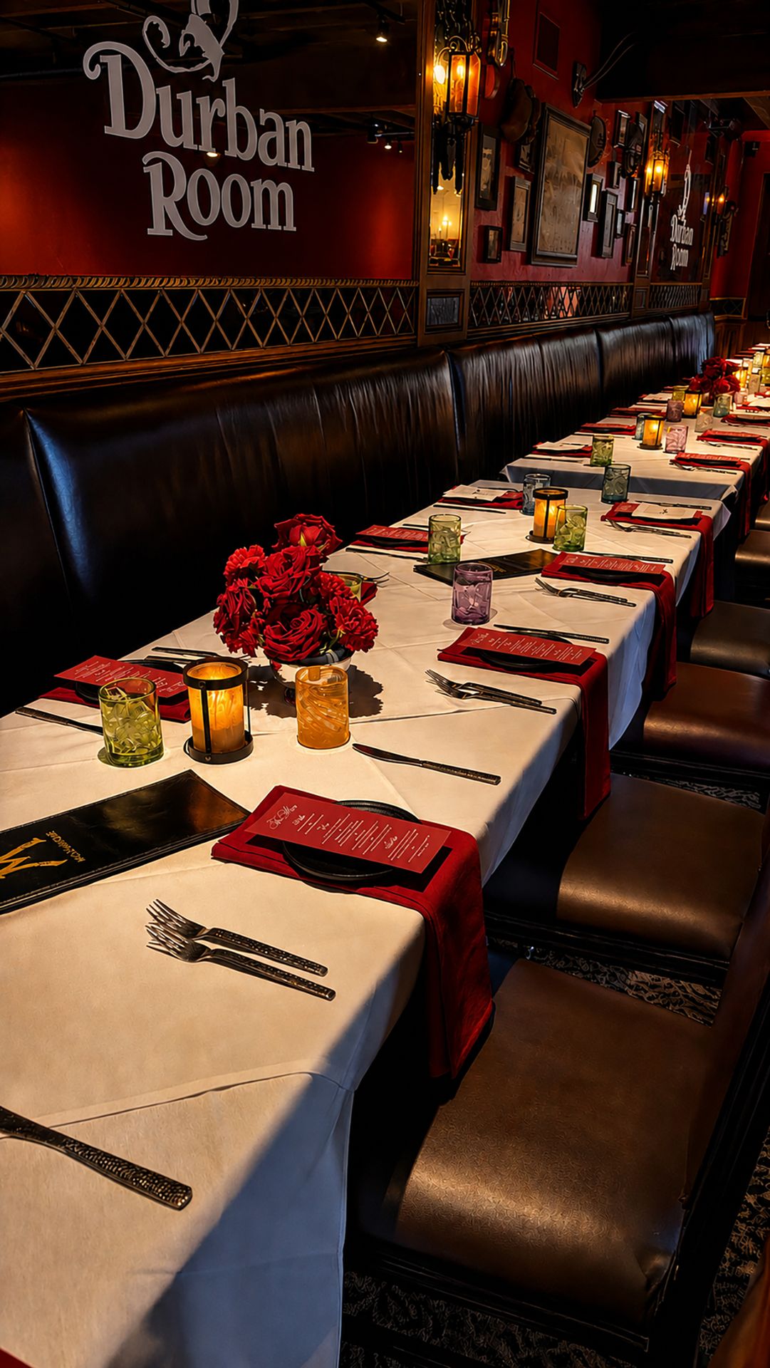 Durban Room banquet table set with white linens, red napkins and flowers for a private event