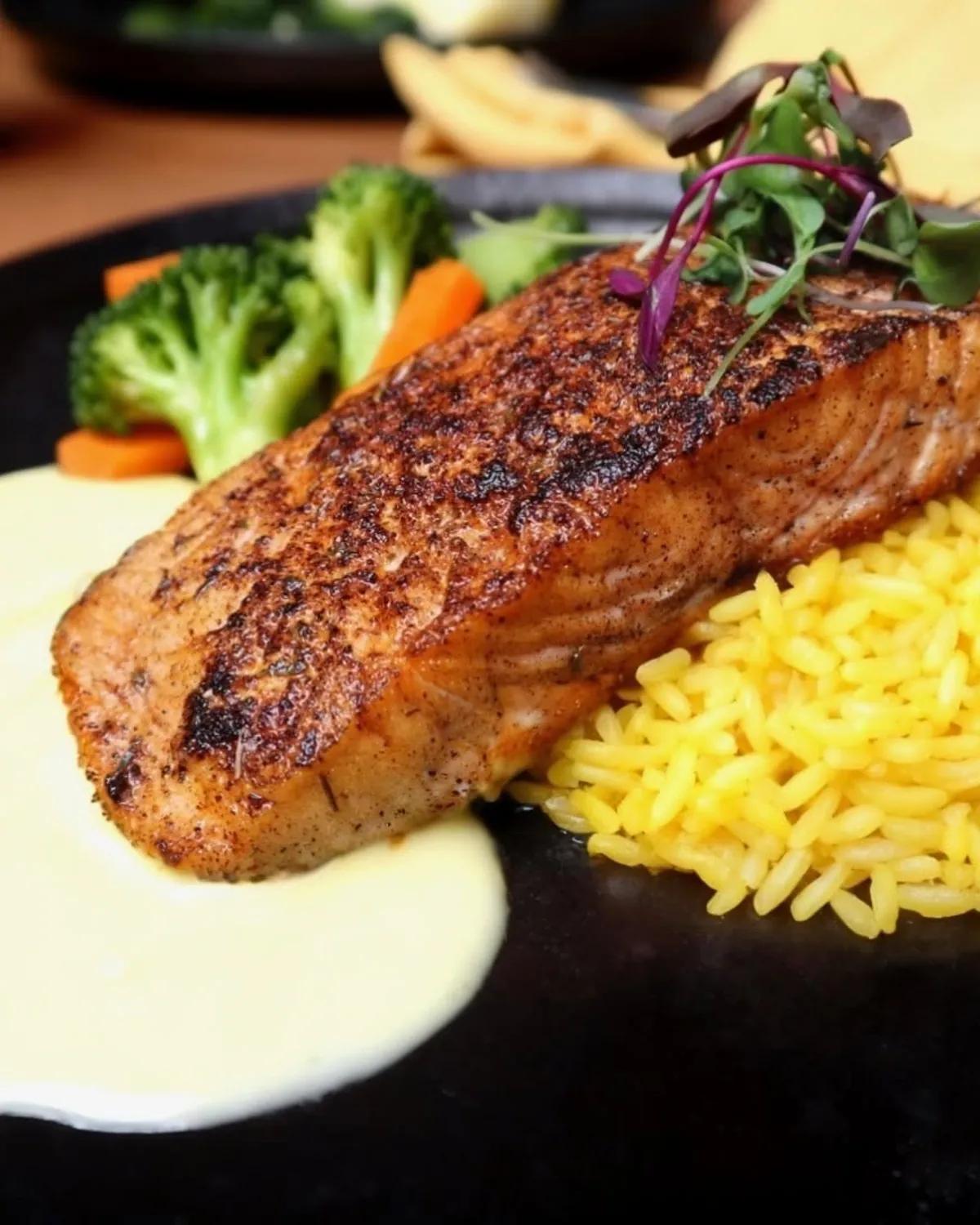 Grilled salmon with yellow rice and vegetables at Mozambique Restaurant