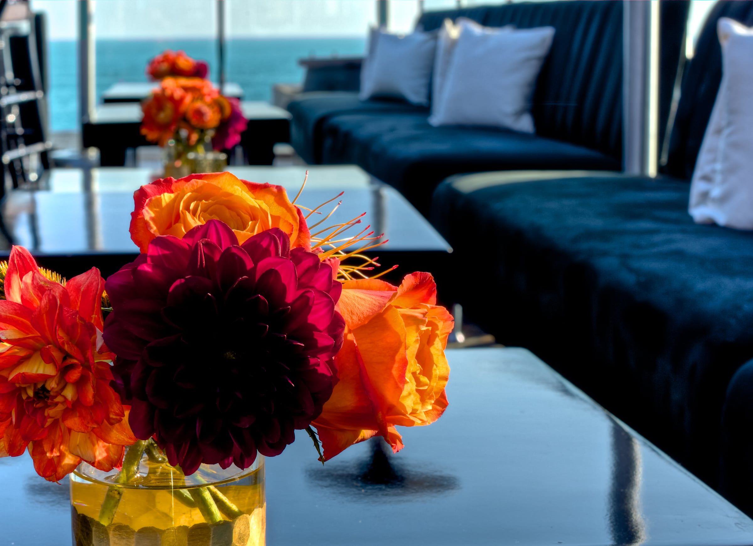Orange and red flowers on a table in the Veranda lounge at Mozambique