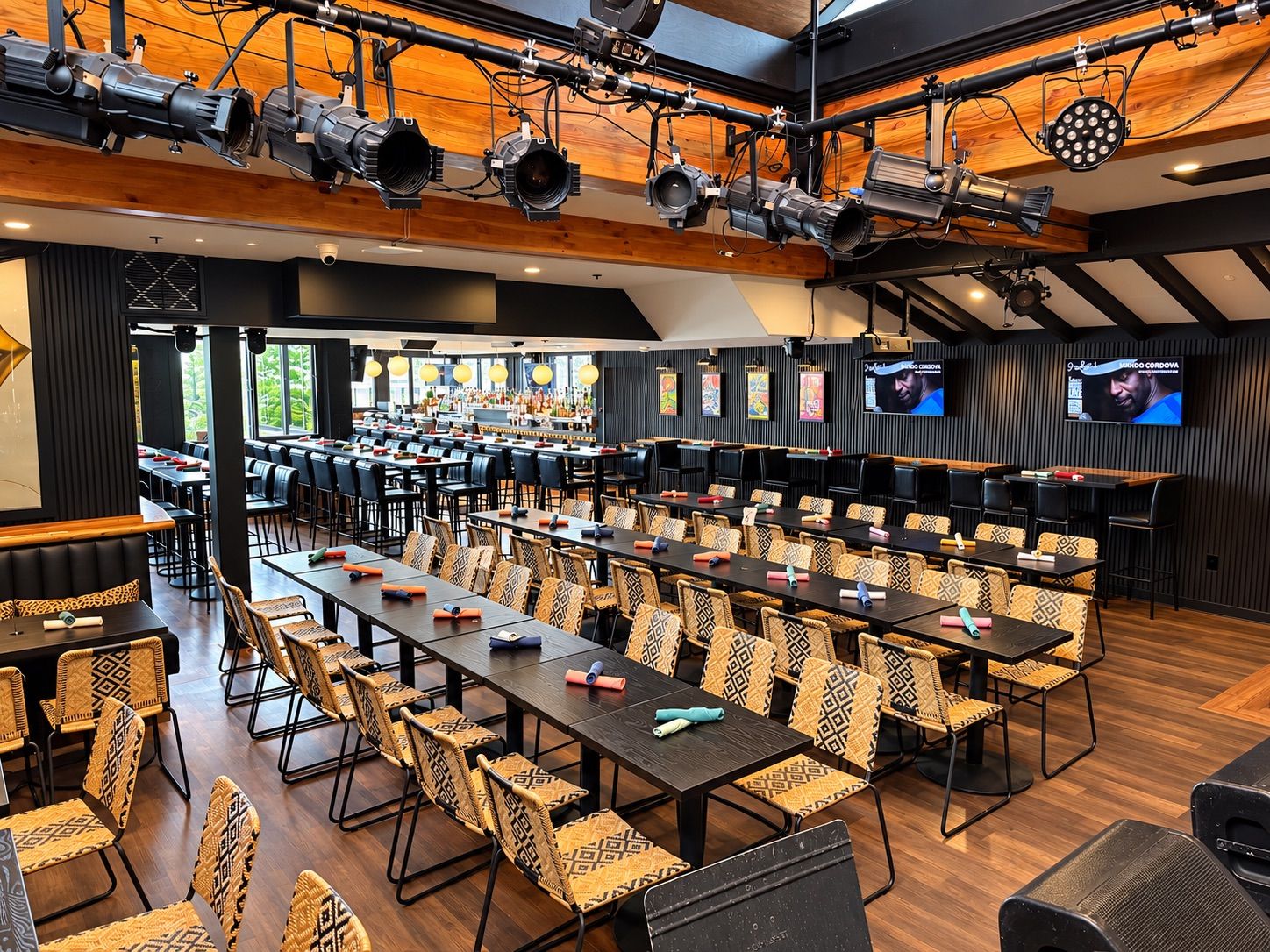 Ivan'z House set with long rows of tables facing the stage under stage lights