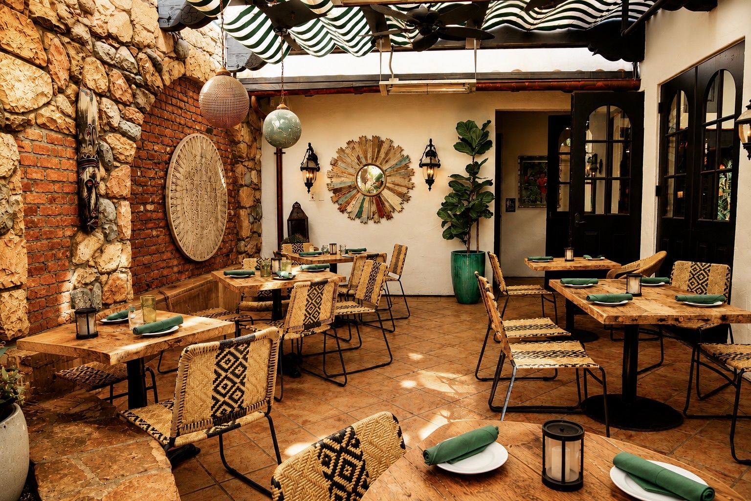 Tables along the brick and stone wall of the Garden Patio