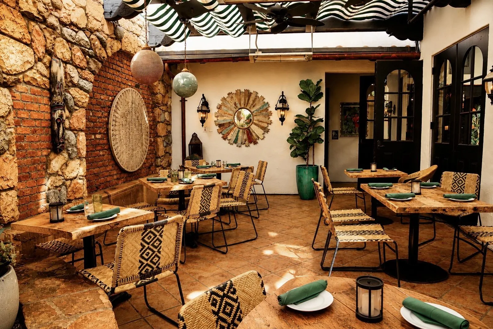 Tables along the brick and stone wall of the Garden Patio