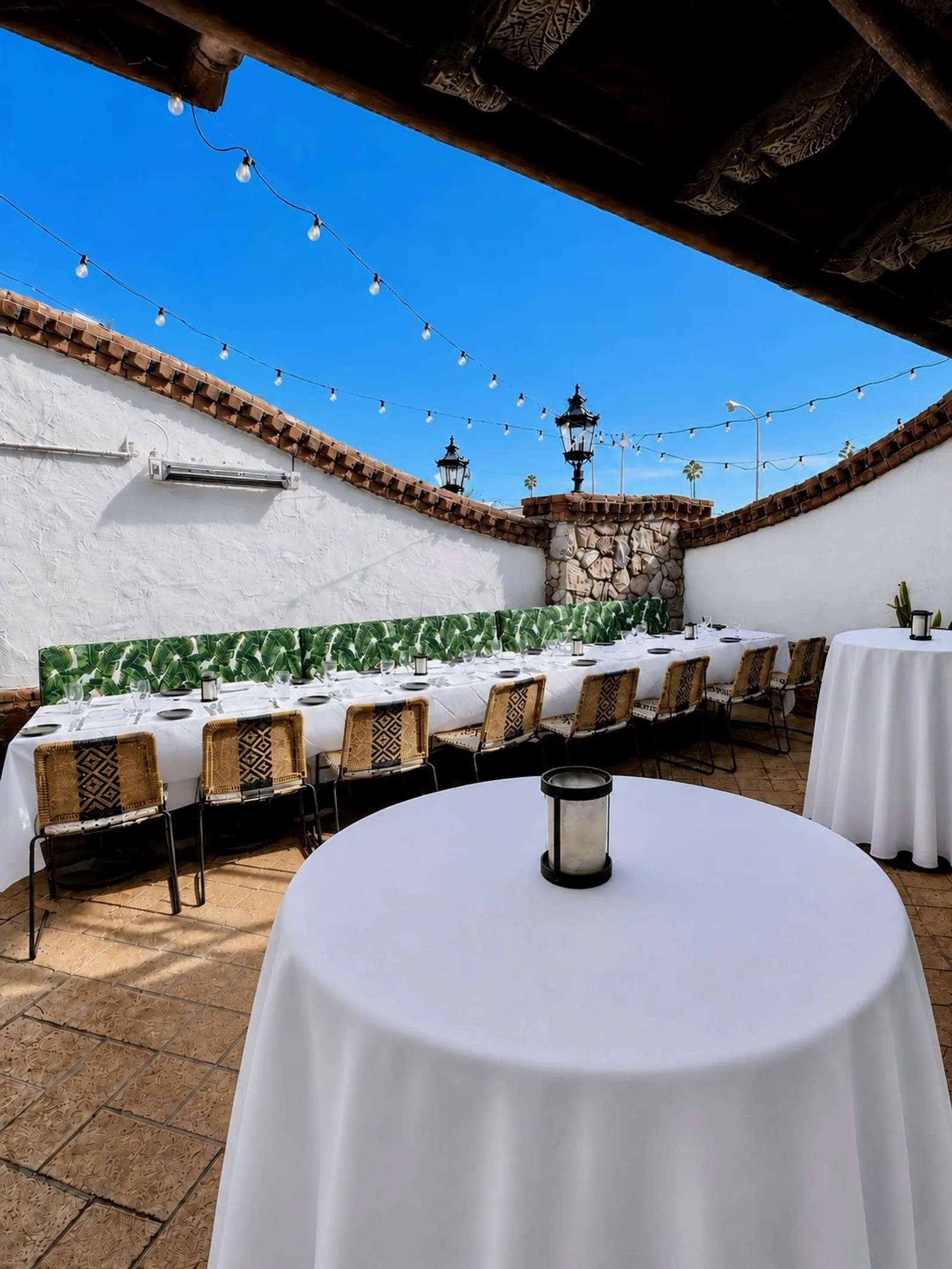 Palm Patio set with white-linen tables for an event