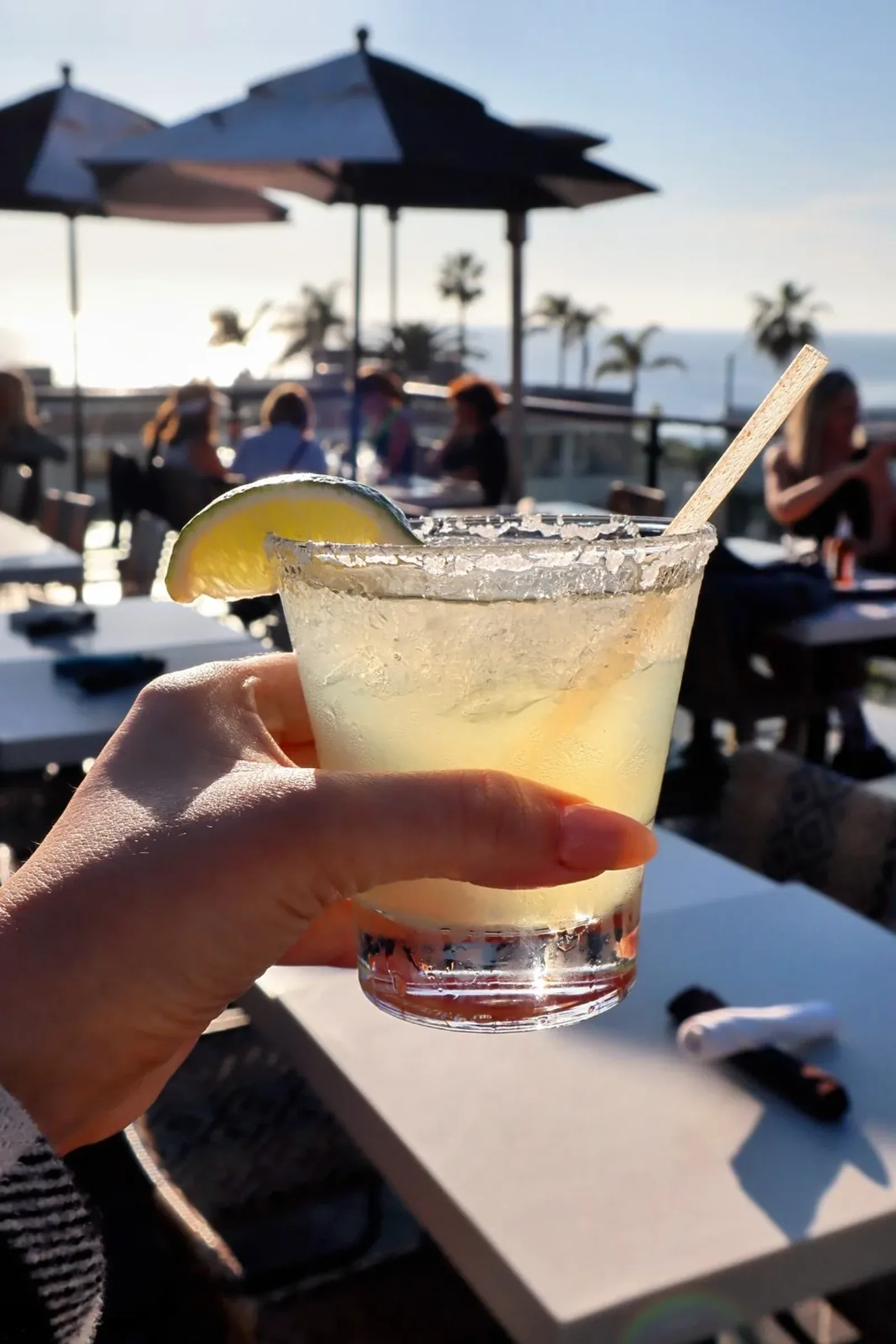Rooftop veranda dining at sunset over the coast
