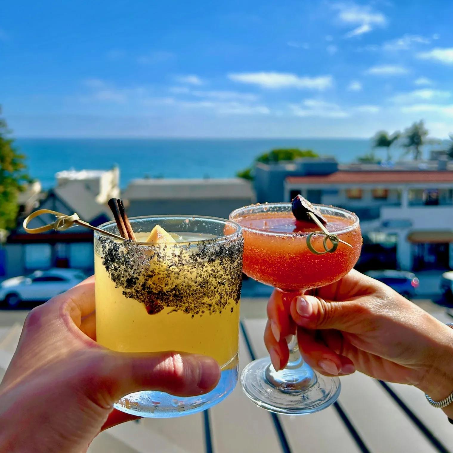 Guests raising drinks on the Mozambique rooftop