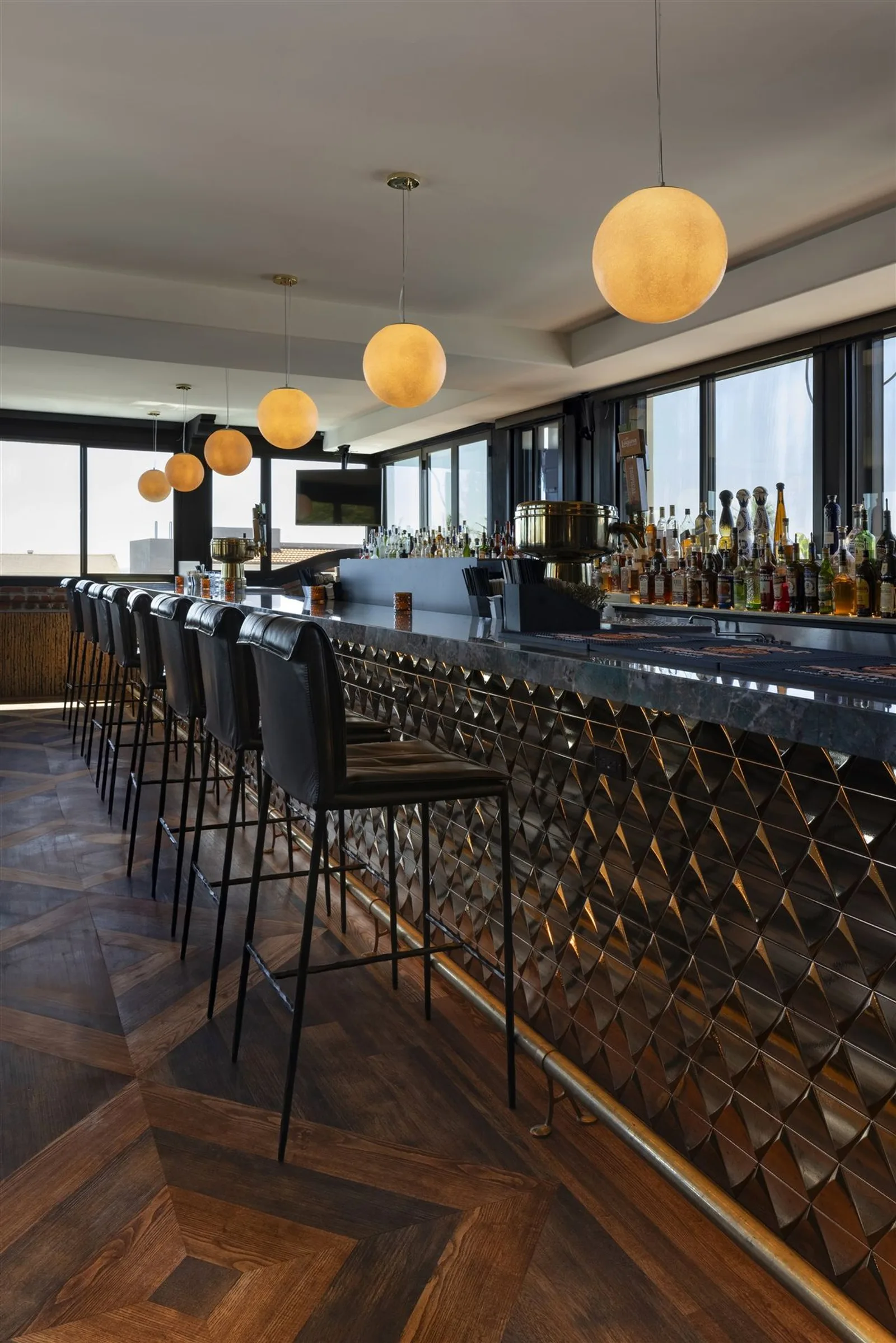 Ivan'z House bar and stools under globe pendant lights