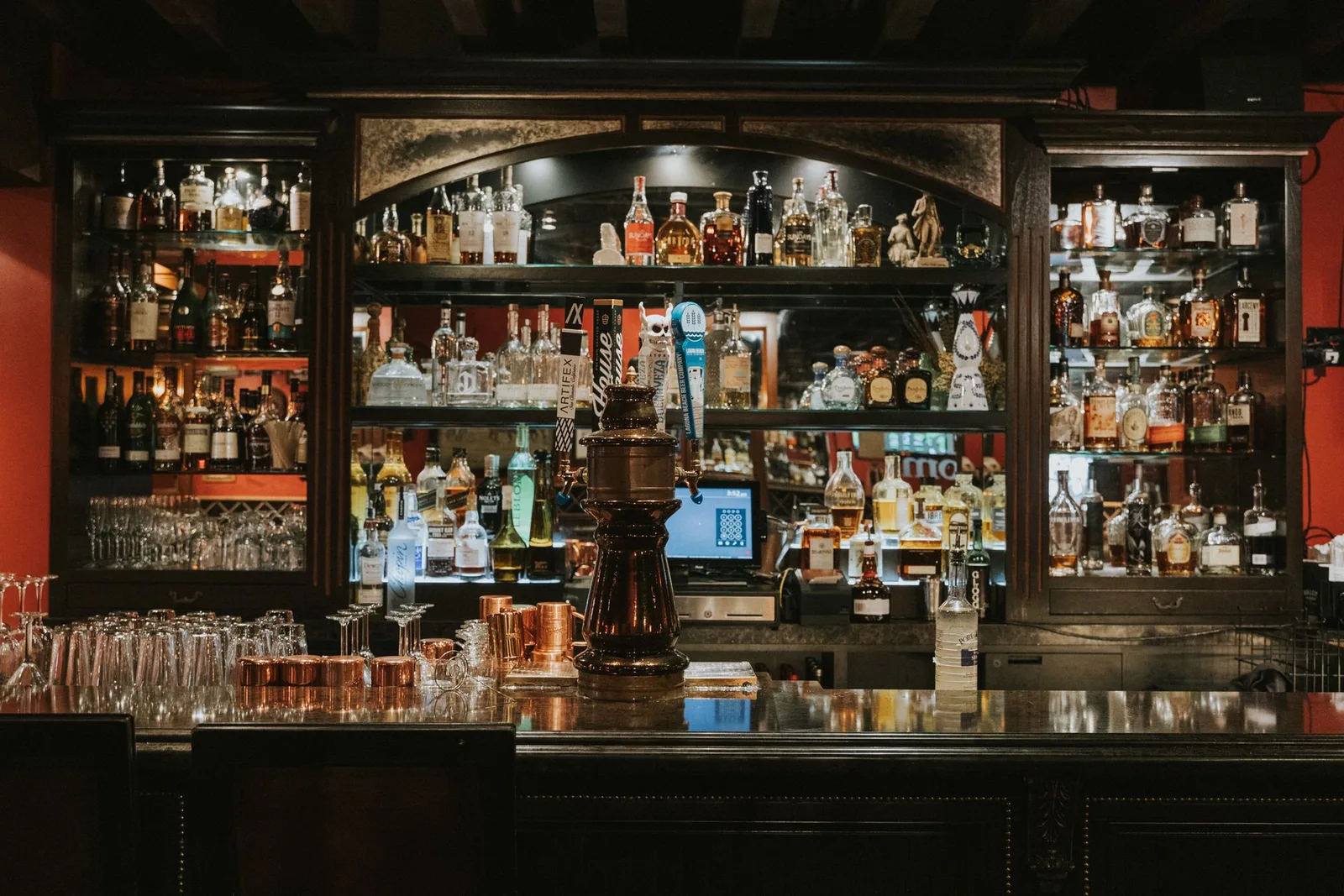 Back bar shelves lined with spirits in the Durban Room