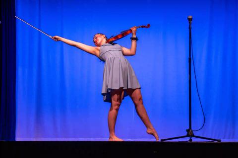 A violinist performs on stage