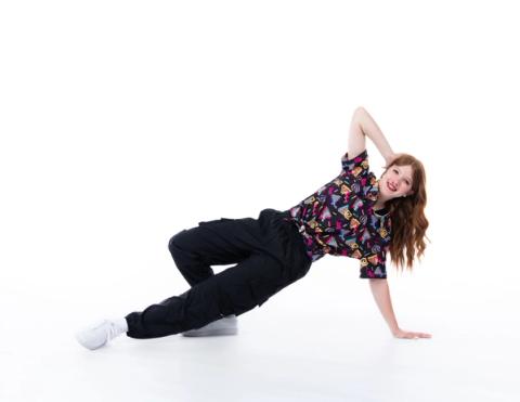 A dancer performs a floor pose