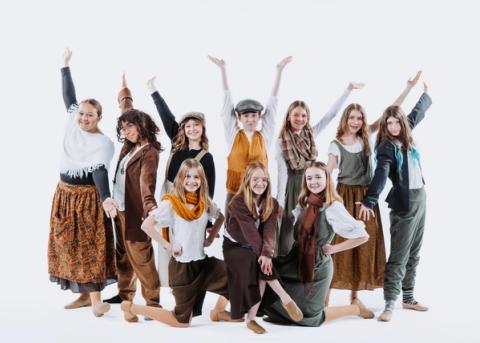 A group of theater performers pose in costume