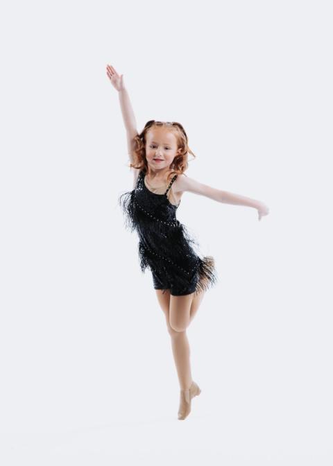 A dancer poses in a black costume