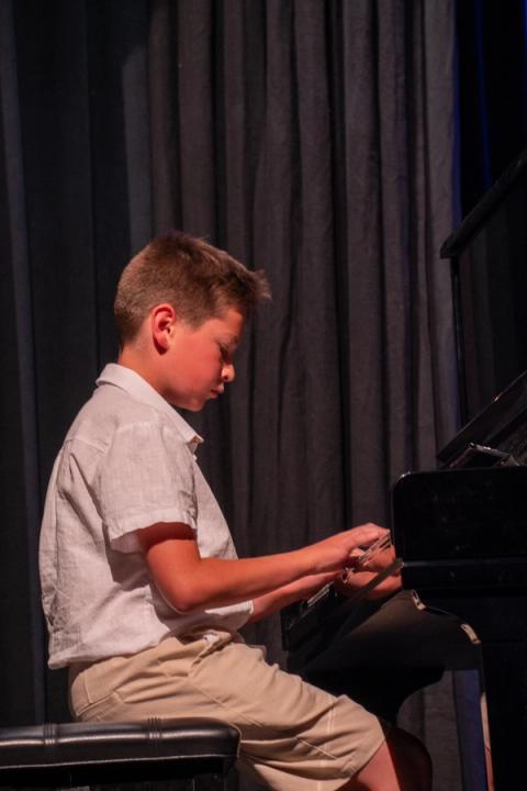 A musician plays piano on stage
