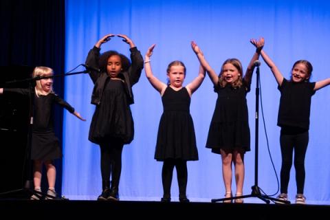 Young performers sing on stage
