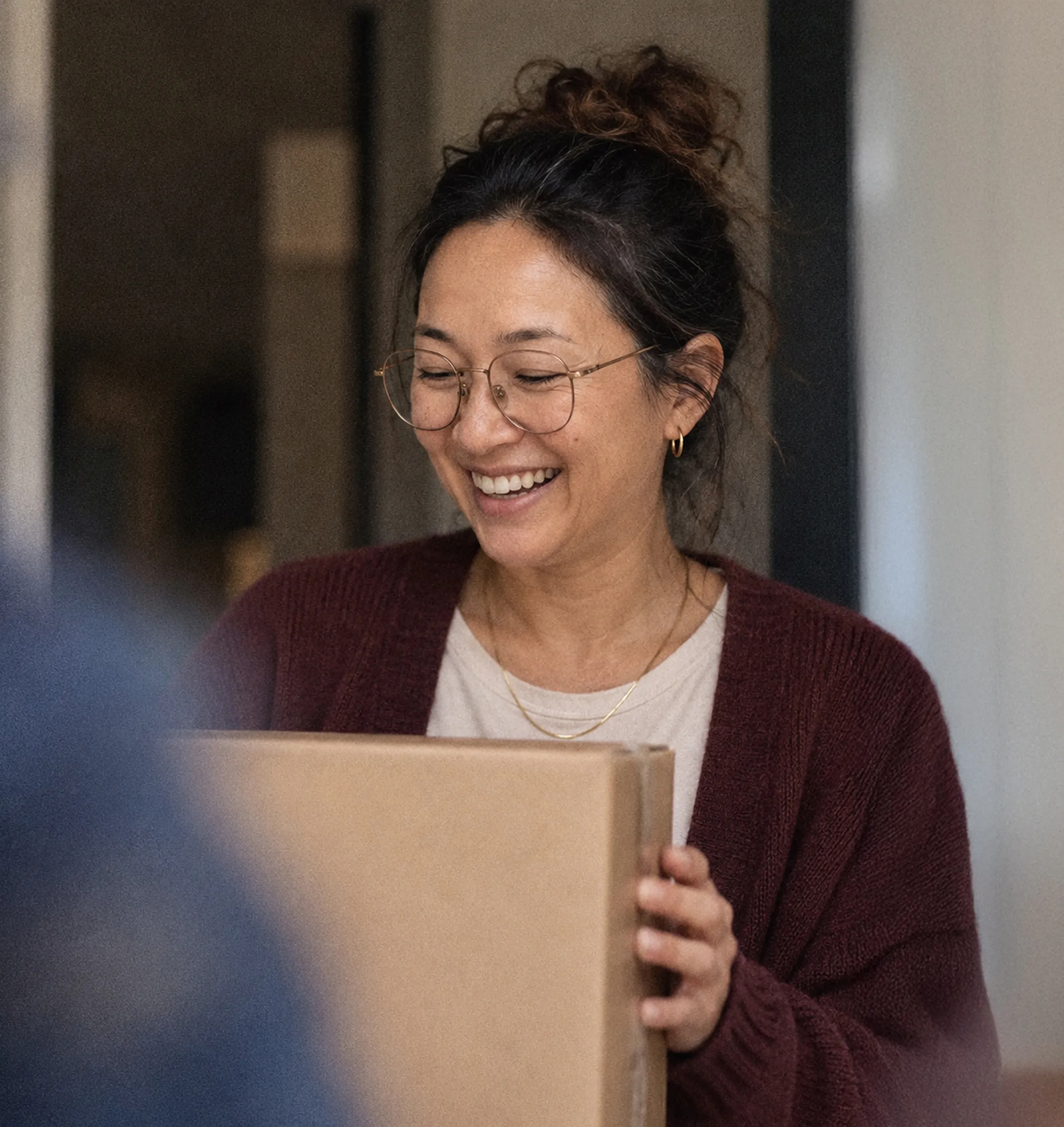 A customer laughing as she receives a package