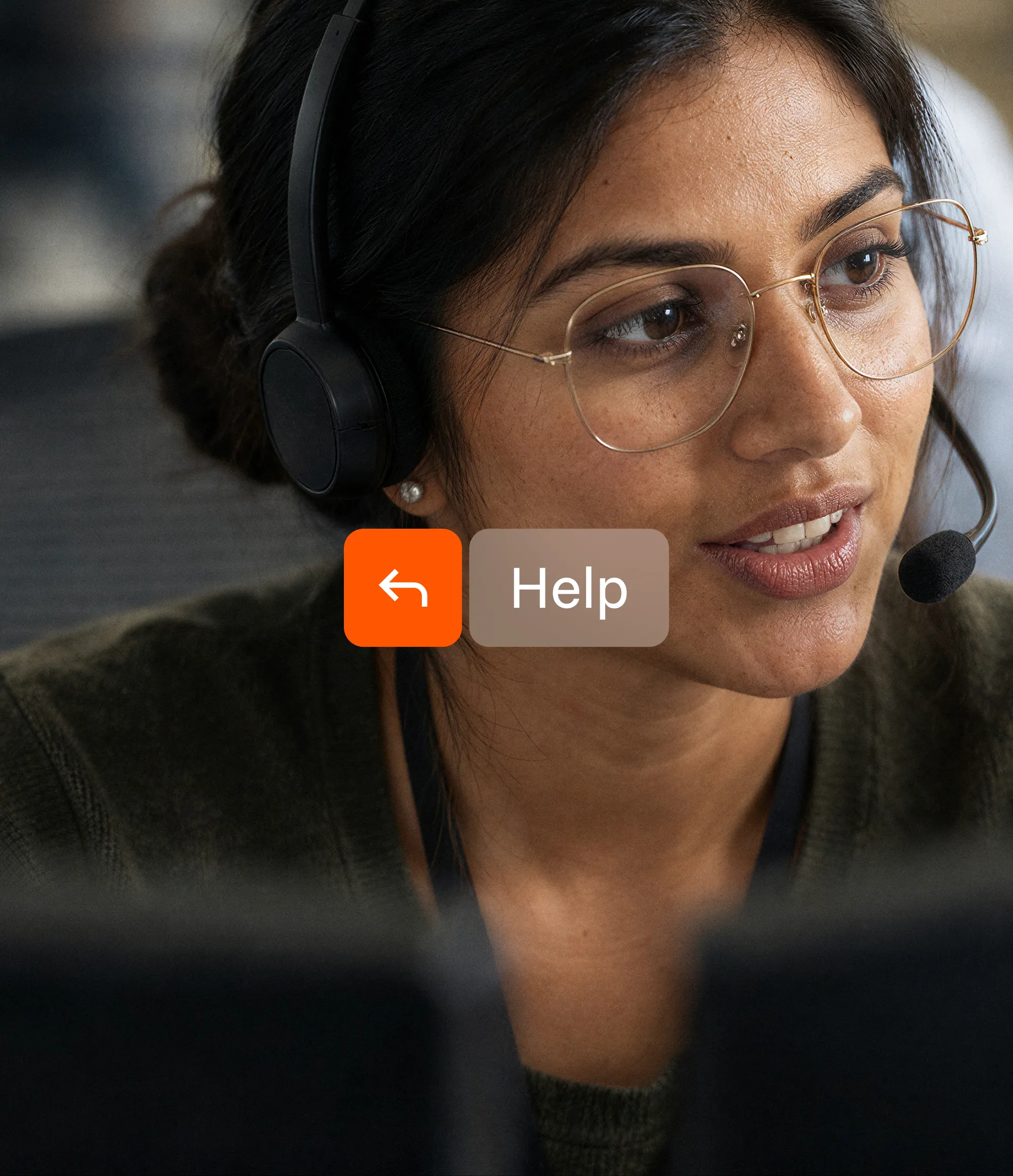 A support agent in a headset talking, with a Help button beside her