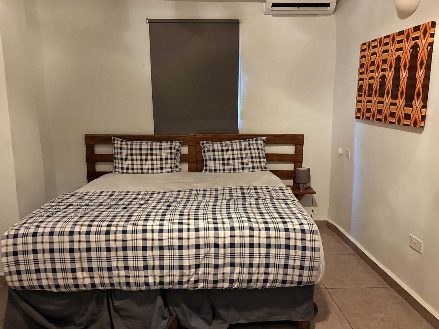 Deluxe standard room with king bed and African art