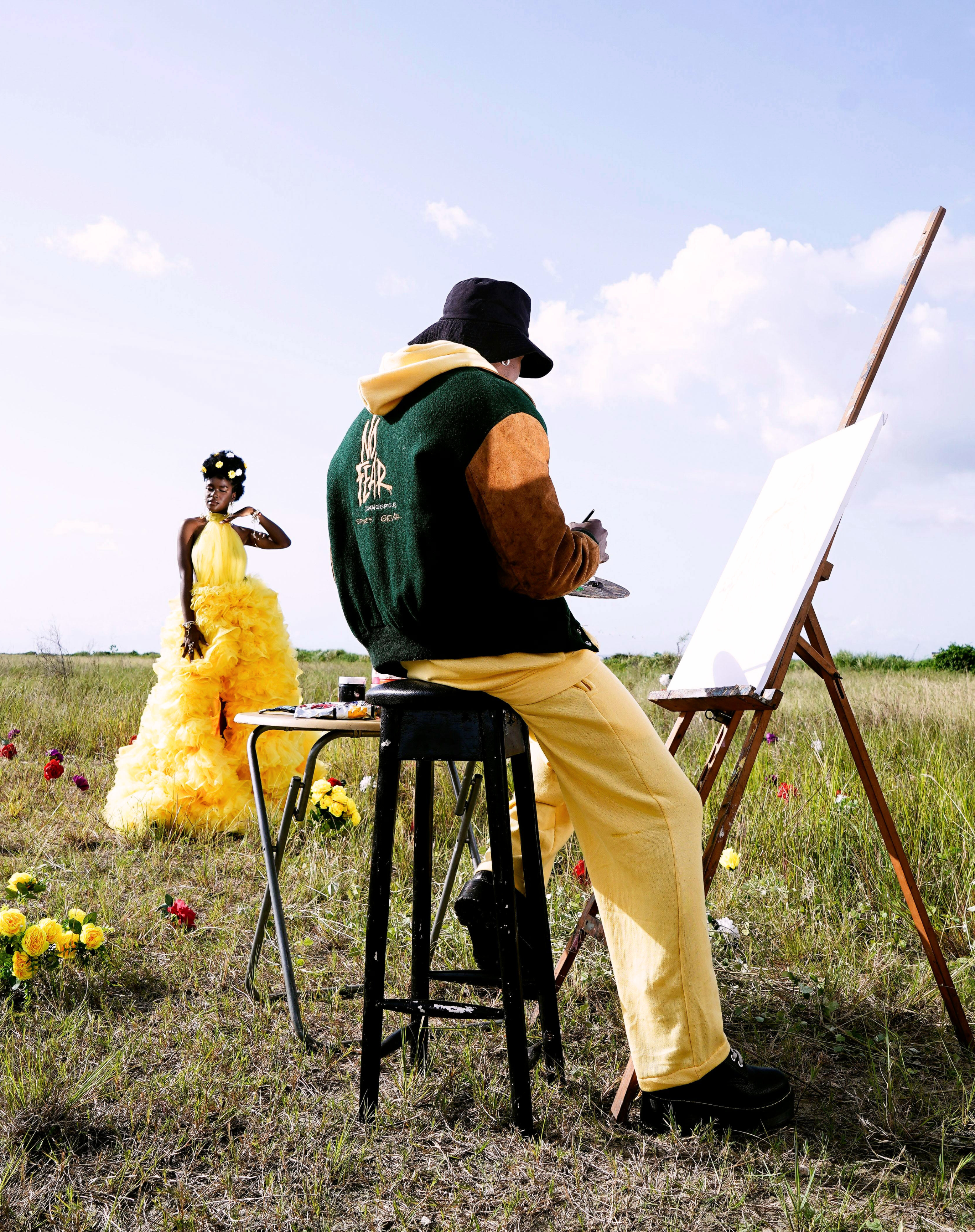 Artist painting live model outdoors