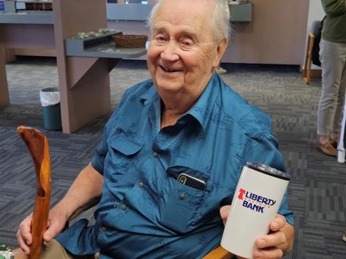 A longtime Liberty Savings Bank customer smiling in-branch