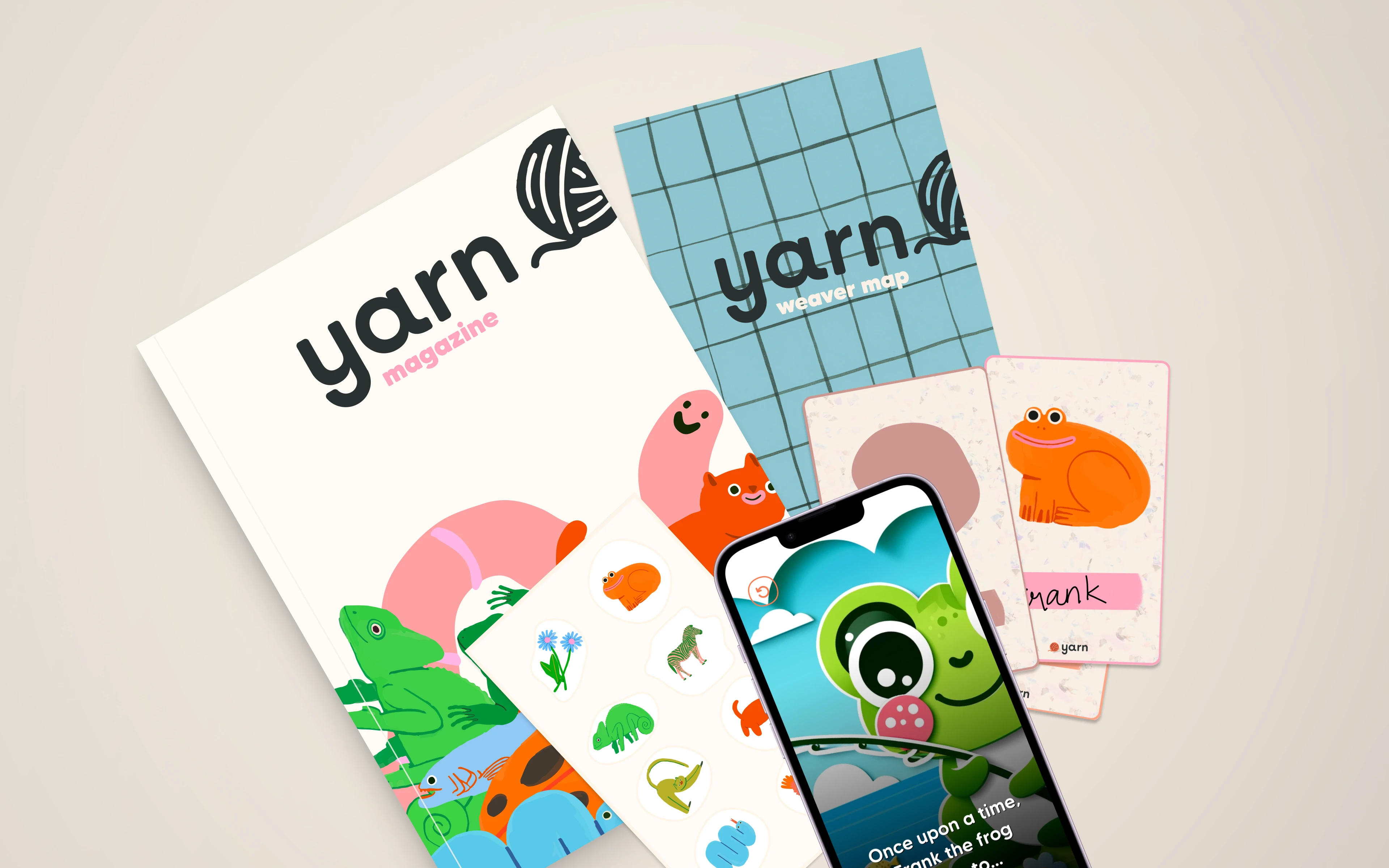 Yarn magazine, weaver map, character cards and the Yarn app on a phone