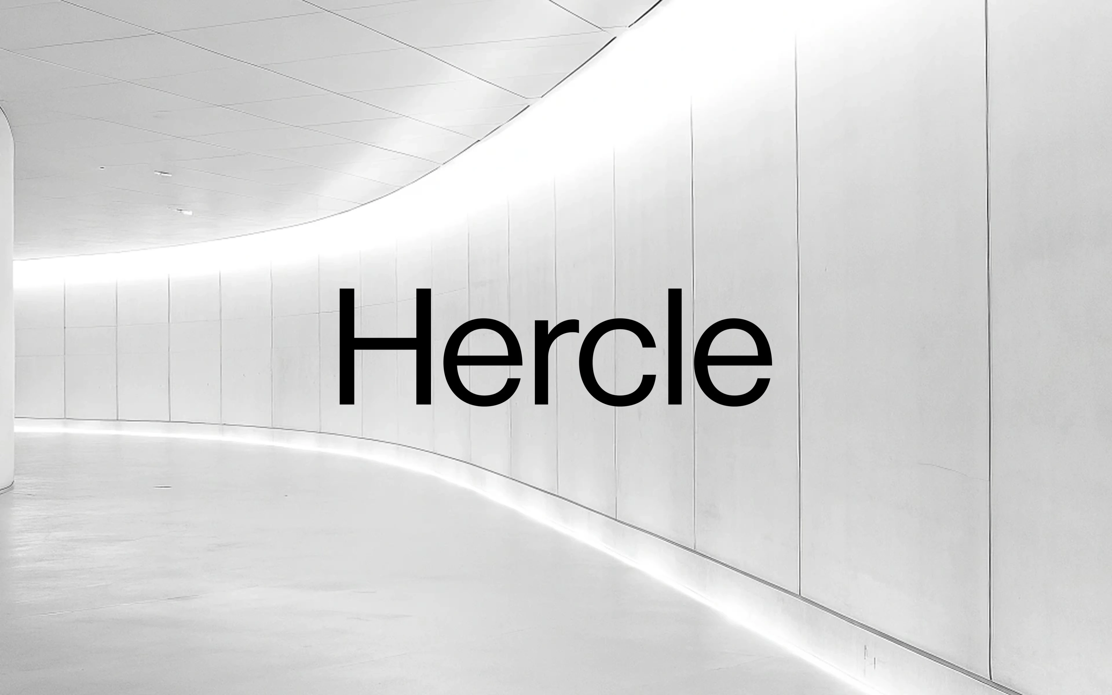 The Hercle wordmark set against a curved concrete facade