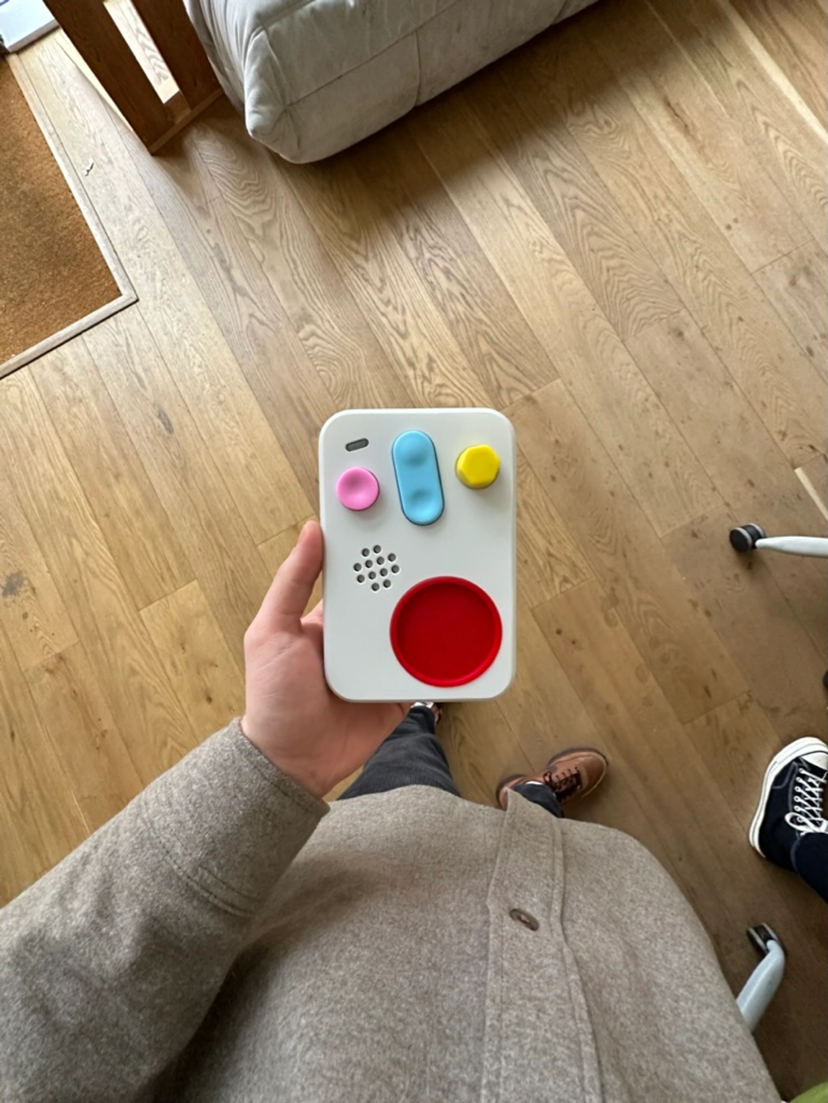 The finished handheld held over a wooden floor