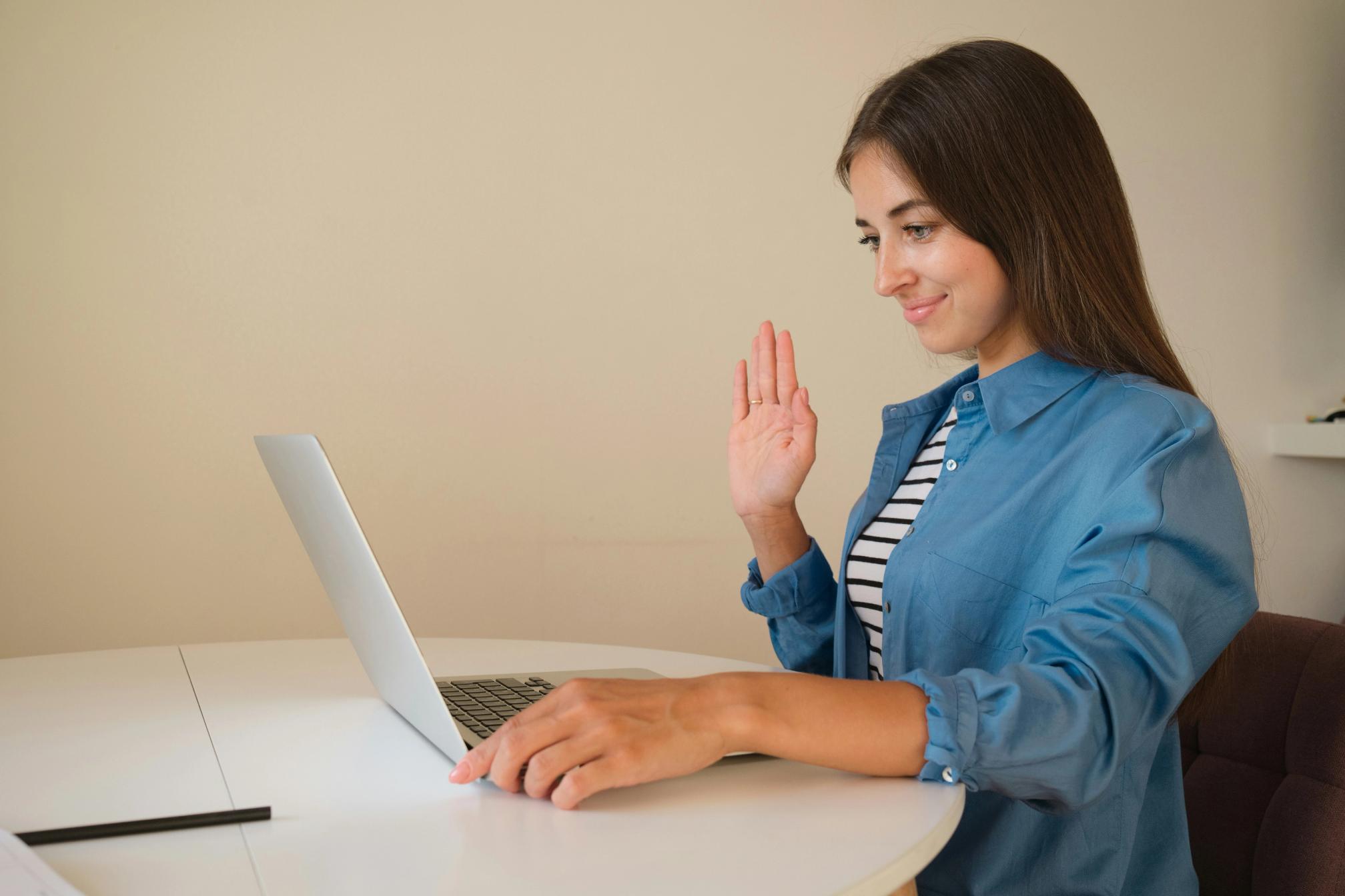 A woman sitting at a table with a laptop
