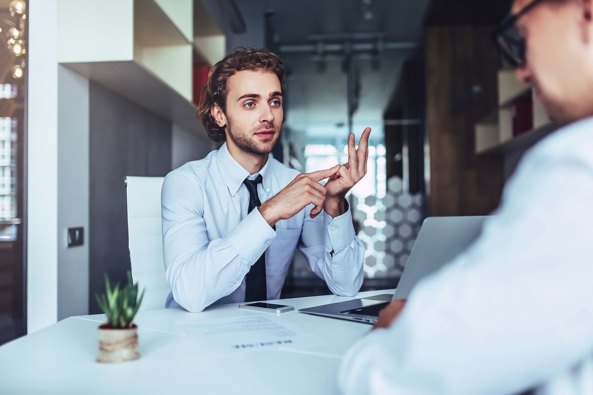 A man conducting a job interview in a modern office